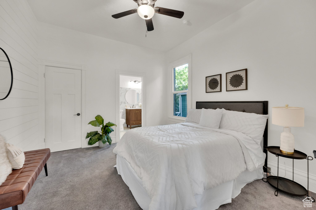 Carpeted bedroom featuring a ceiling fan and ensuite bathroom