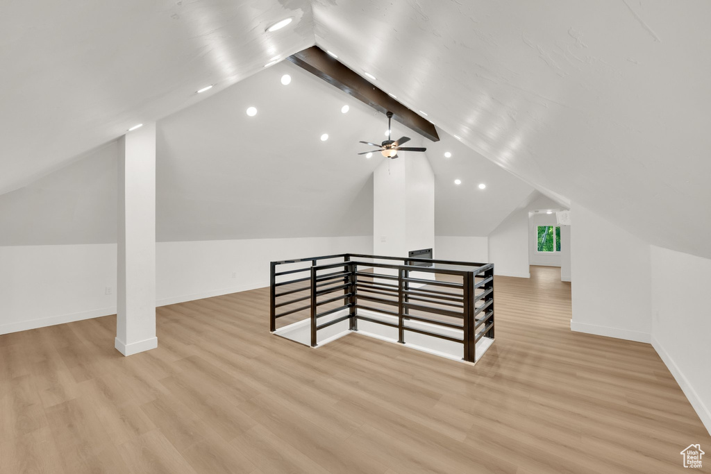Additional living space with light wood finished floors, baseboards, and recessed lighting