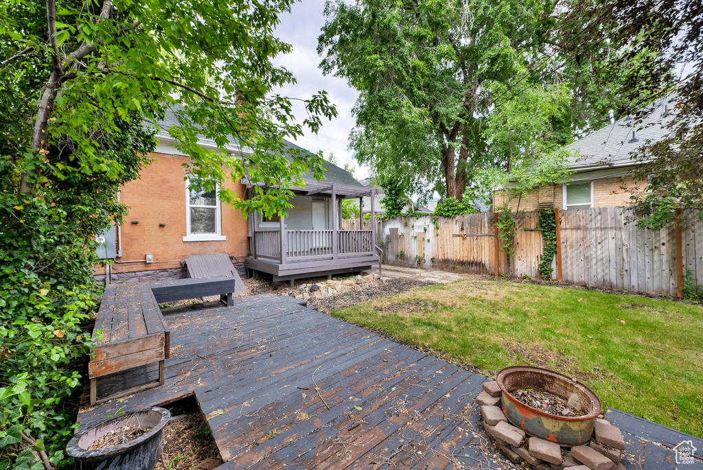 View of yard featuring a fire pit and a wooden deck