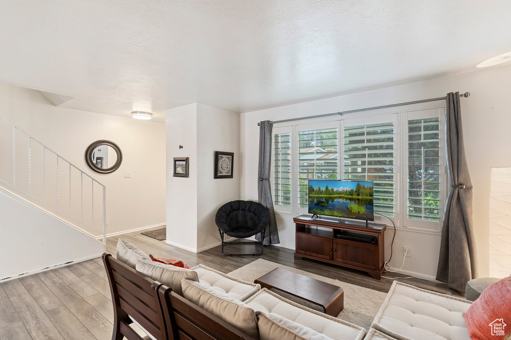 Living area with wood finished floors and baseboards