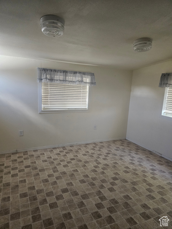Spare room featuring baseboards