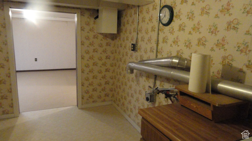 Finished basement featuring baseboards and wallpapered walls