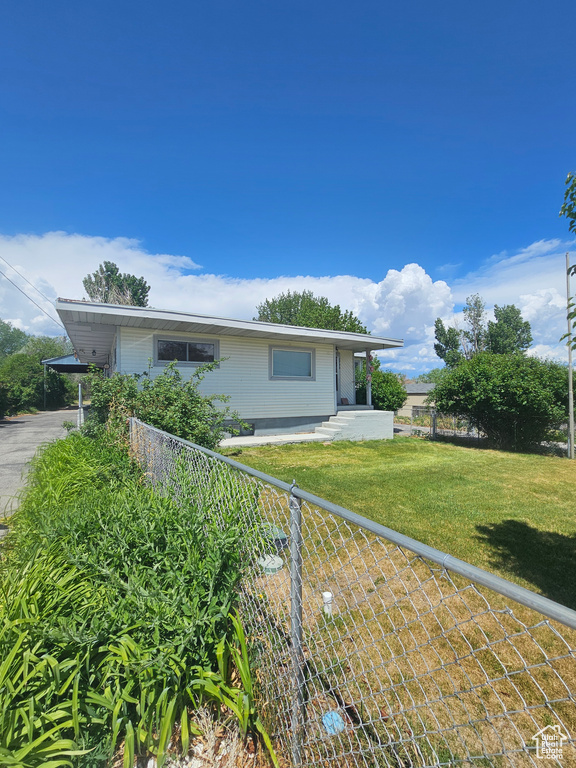 View of front of house featuring an attached carport
