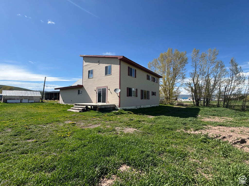 Back of property with a yard