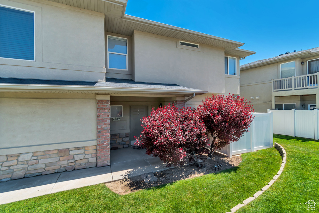 Entrance to property with stucco siding