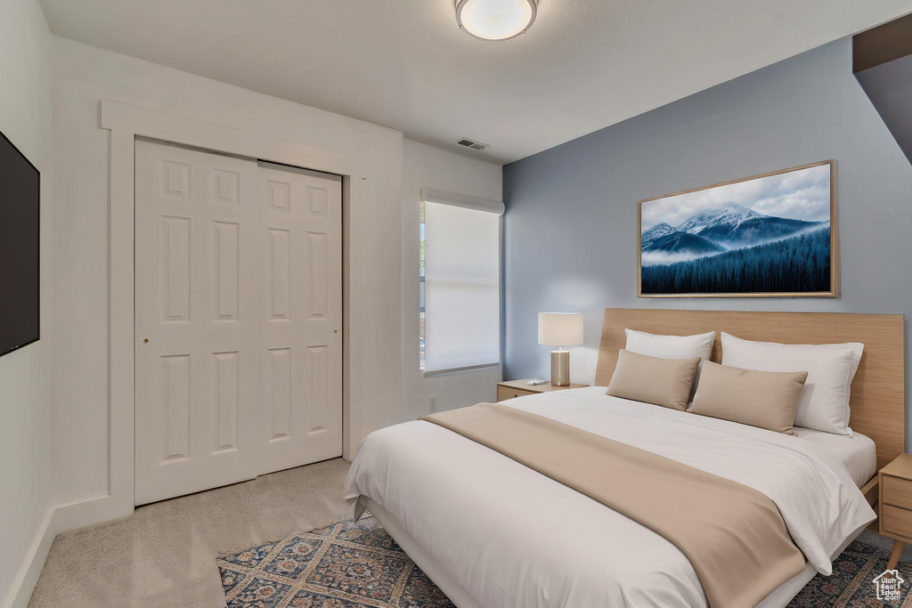 Bedroom with carpet floors, a closet, and baseboards