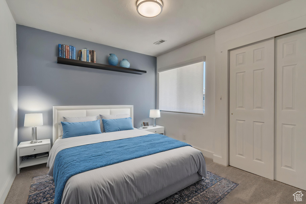 Bedroom with carpet floors, a closet, and baseboards
