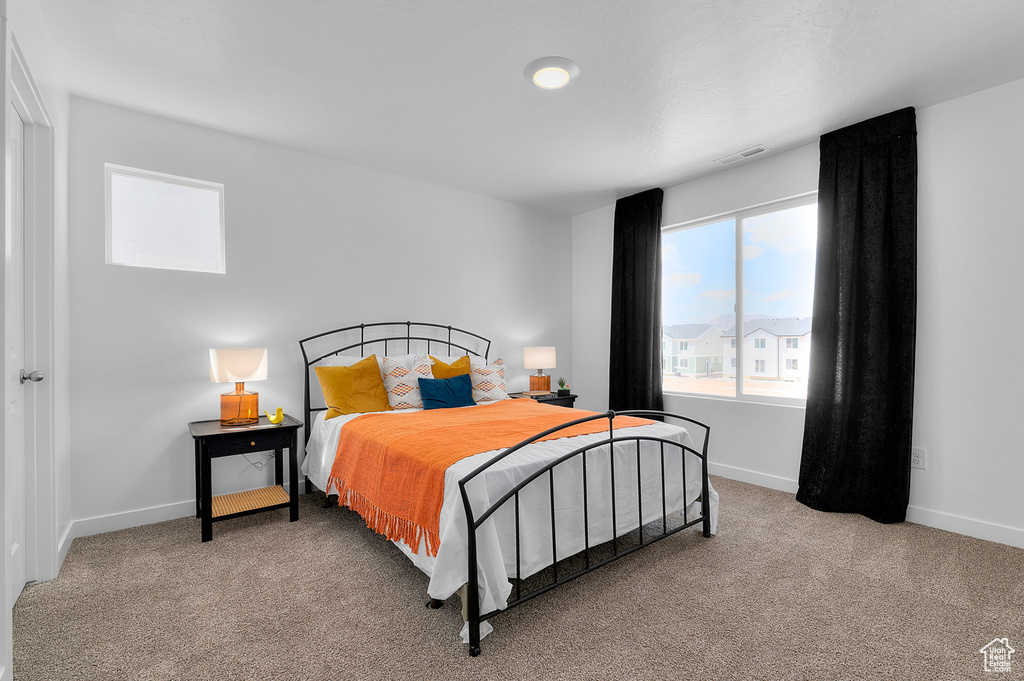 Carpeted bedroom featuring baseboards