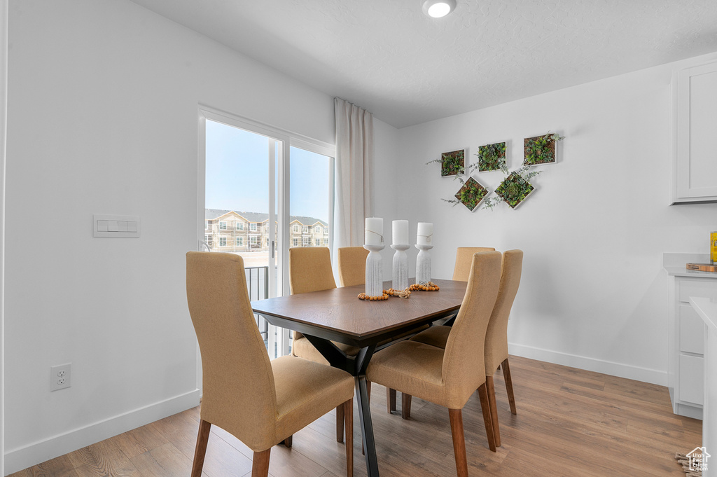 Dining room with baseboards and light wood finished floors