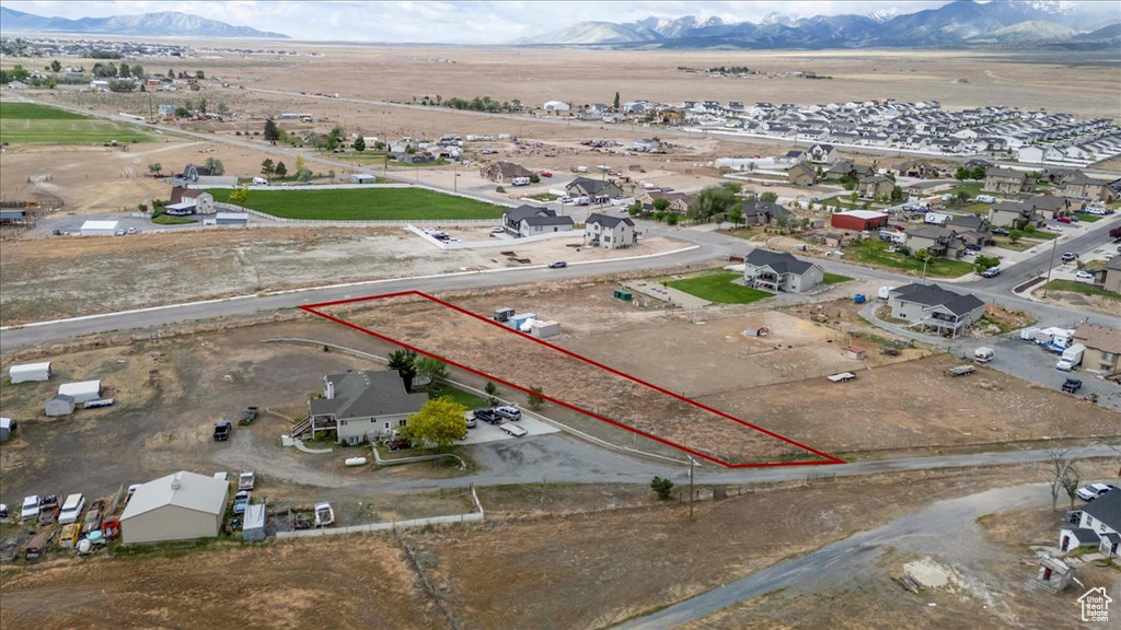 Aerial view of residential area featuring mountains and property parcel outlined