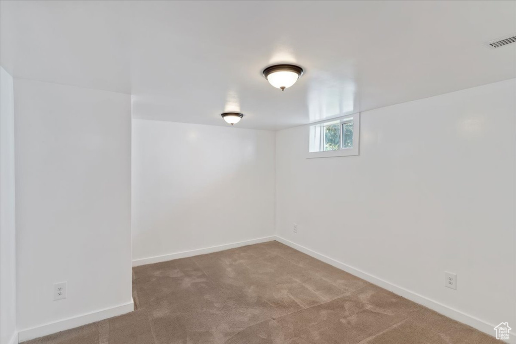 Basement featuring carpet floors and baseboards