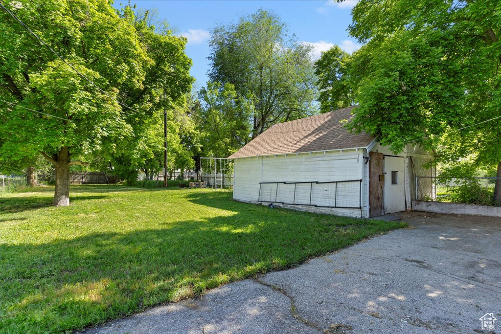 Detached garage featuring a storage shed