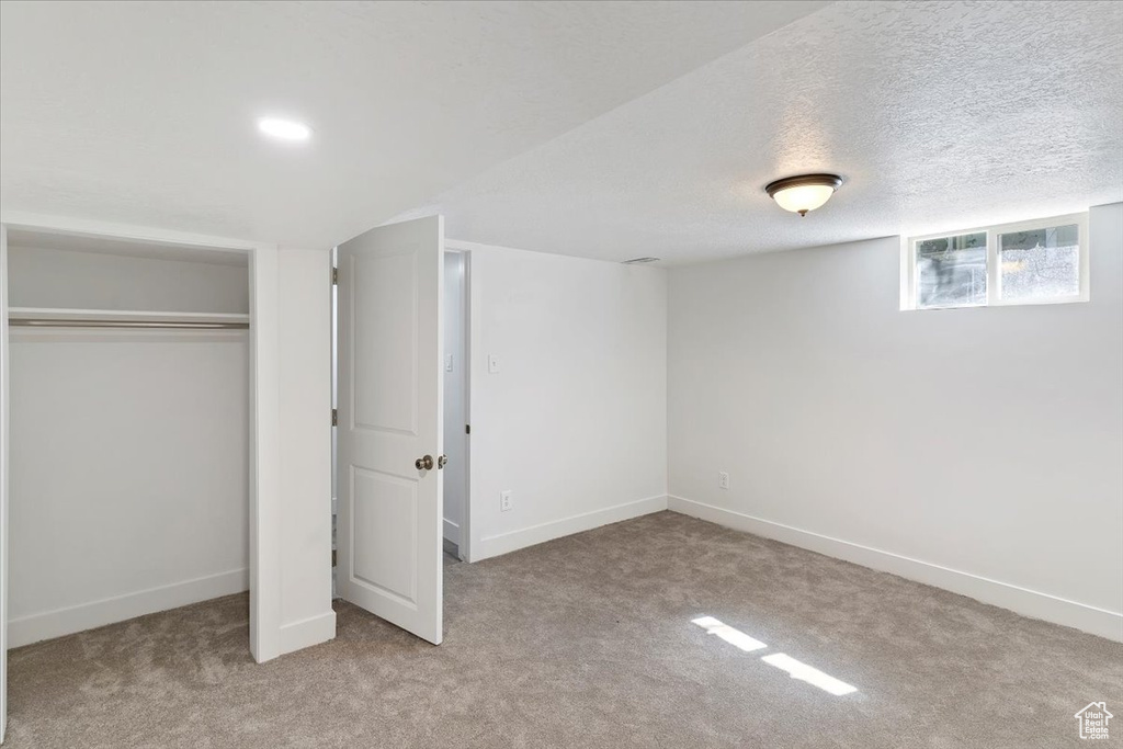Unfurnished bedroom with carpet, baseboards, and a closet