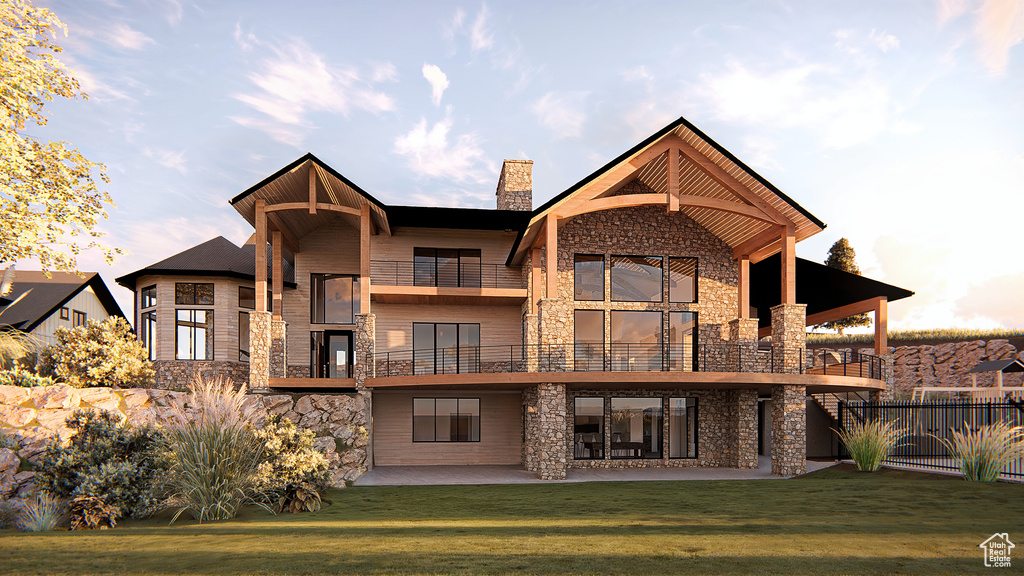 Back of house with stone siding, a balcony, a patio, and a chimney