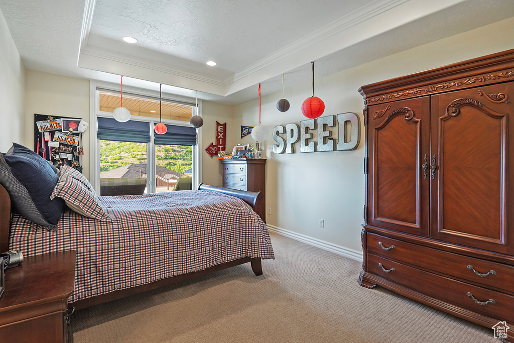 Bedroom with light carpet, a raised ceiling, baseboards, crown molding, and recessed lighting