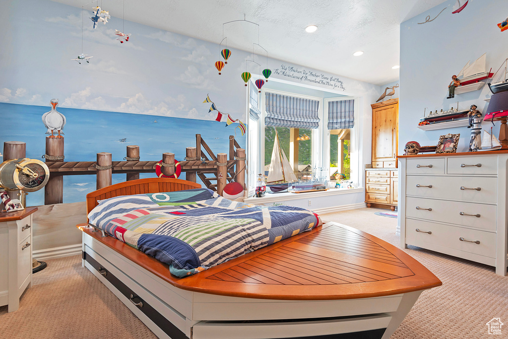 Bedroom with light colored carpet, recessed lighting, and baseboards