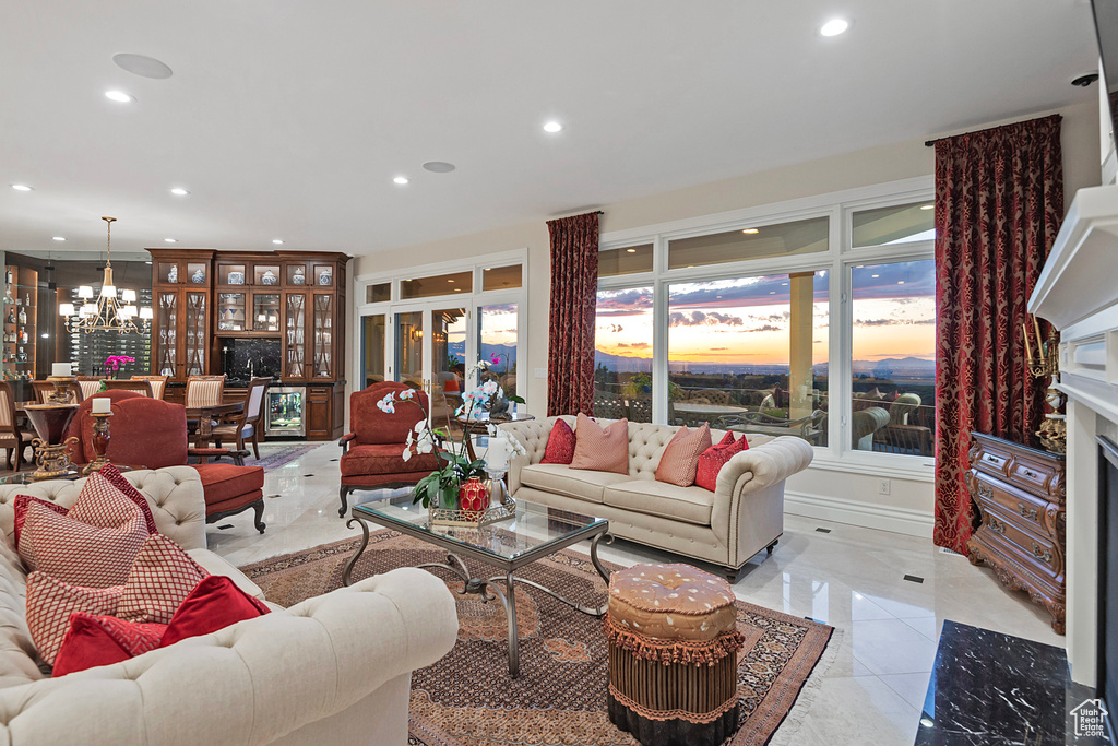Living area with a chandelier, recessed lighting, and light tile patterned floors