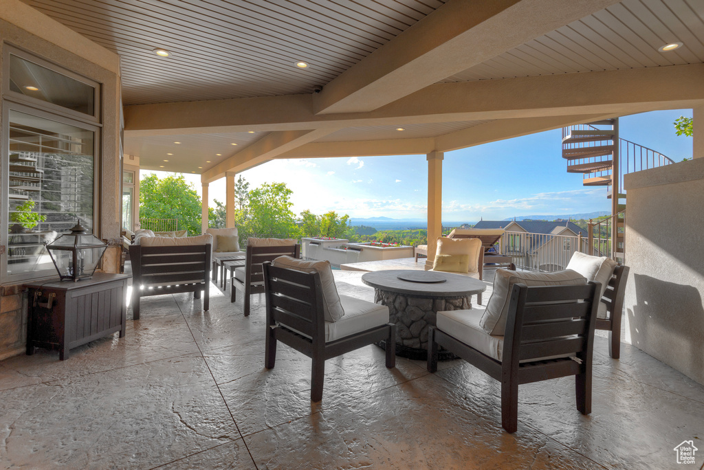 View of patio with an outdoor living space with a fire pit