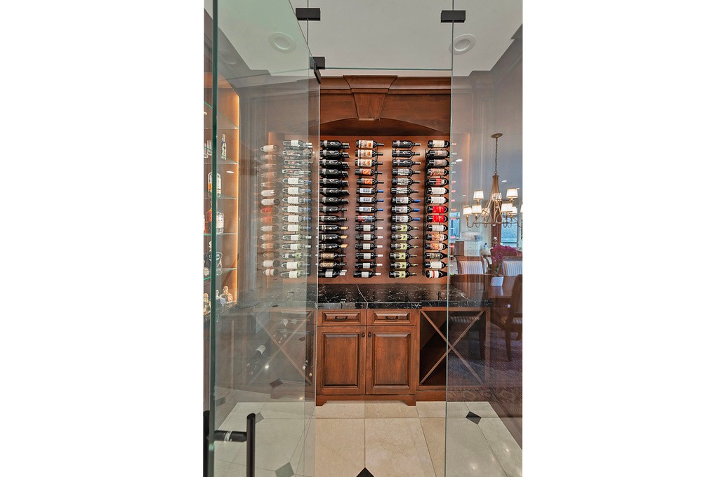 Wine cellar with light tile patterned floors and a chandelier