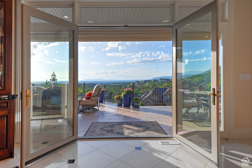 Doorway with a mountain view and tile patterned flooring