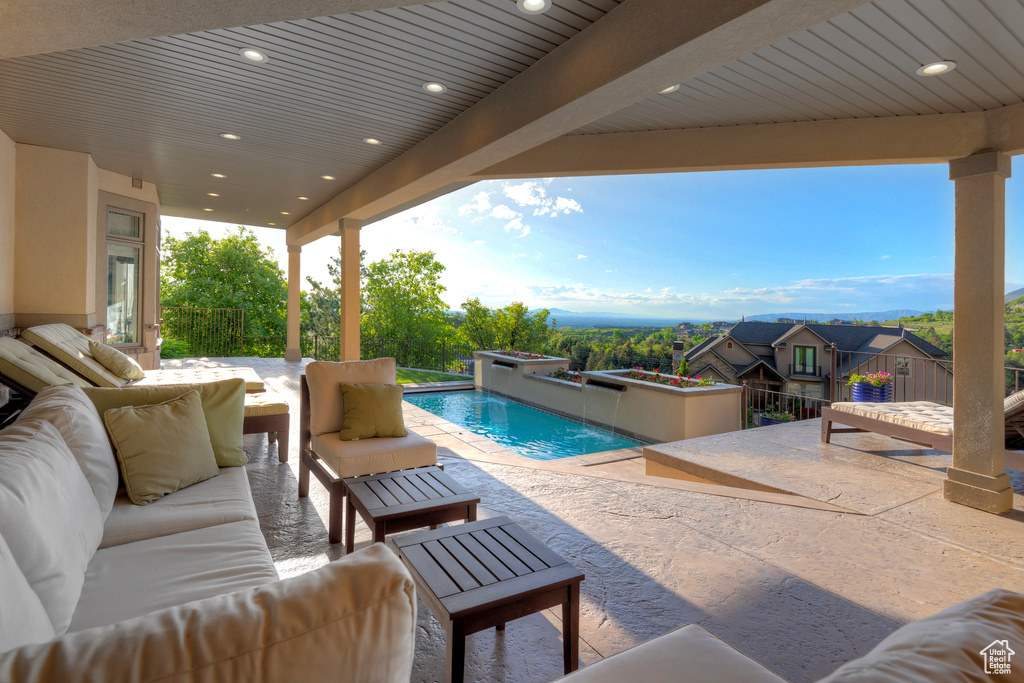 Swimming pool with an outdoor hangout area and a patio