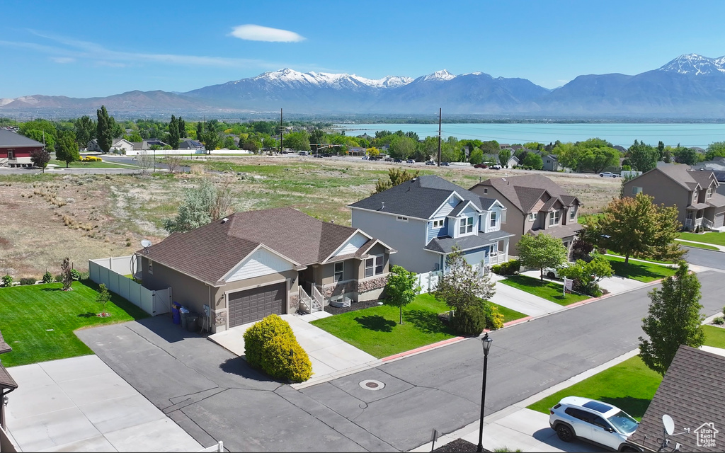 View of mountain background featuring a large body of water and nearby suburban area