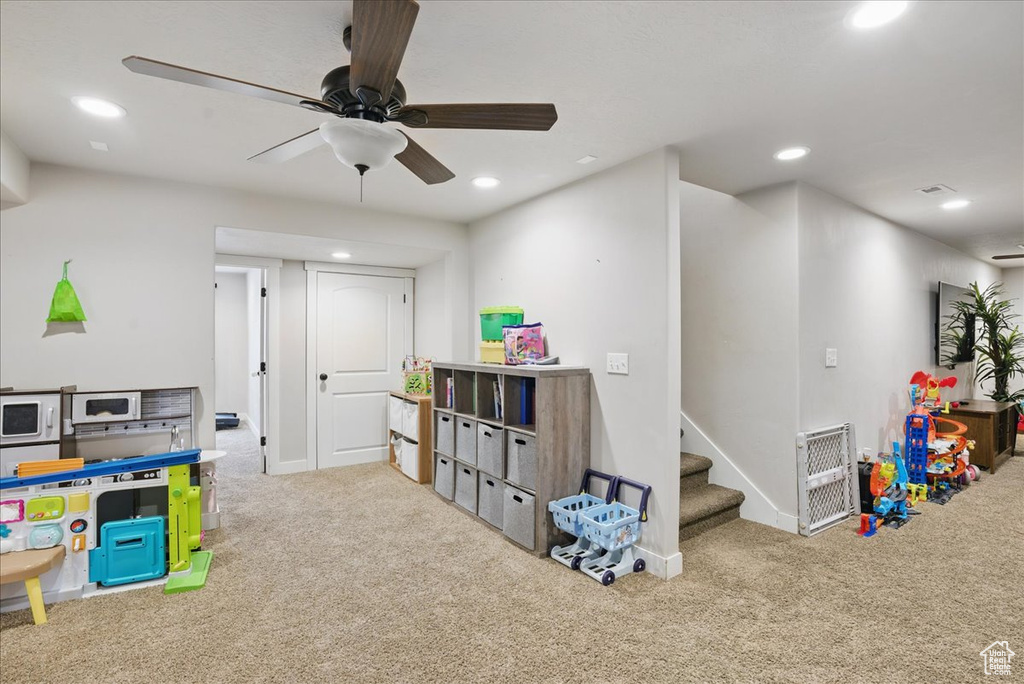 Recreation room with carpet flooring, recessed lighting, a ceiling fan, and baseboards