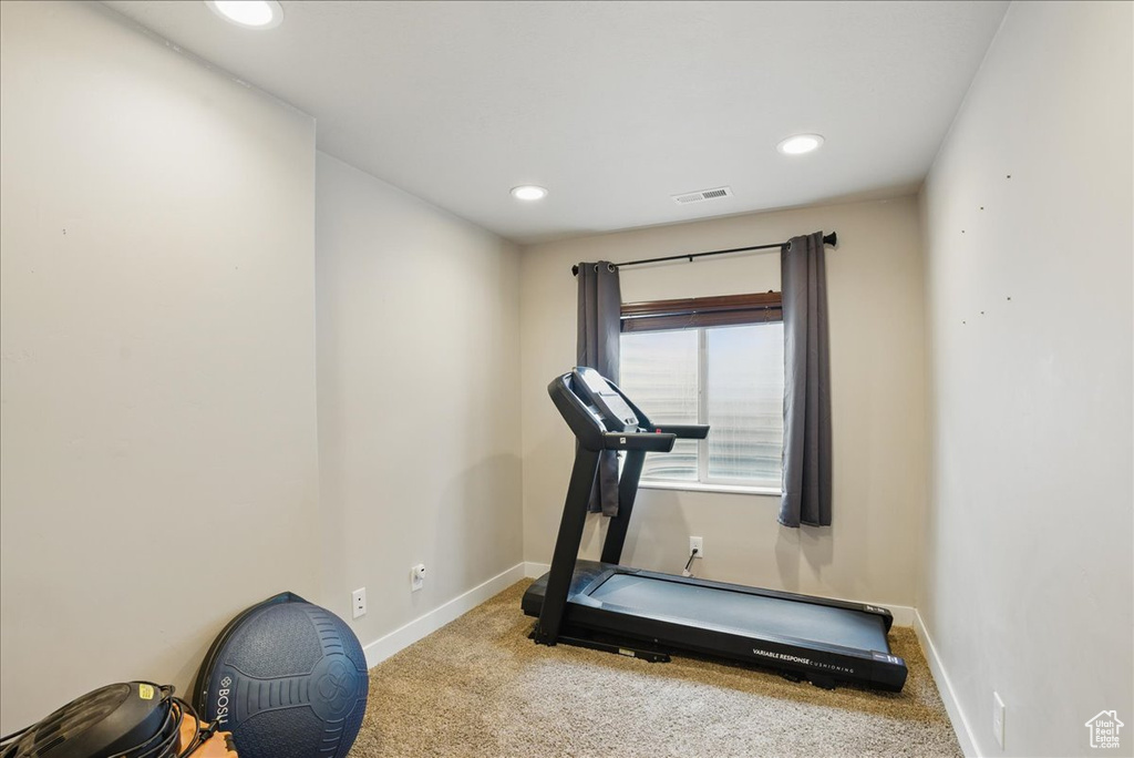 Exercise room featuring carpet floors, baseboards, and recessed lighting