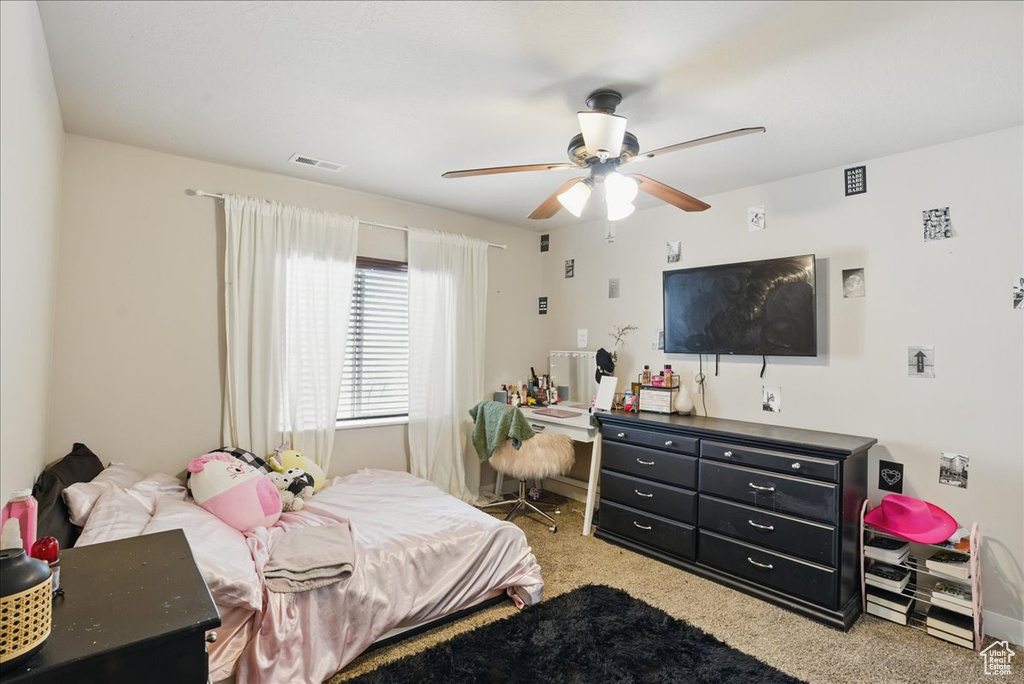 Carpeted bedroom with ceiling fan