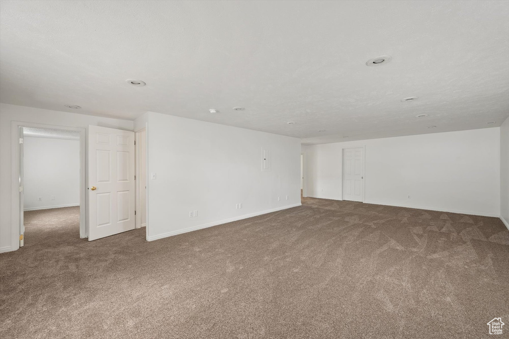 Unfurnished room with carpet and baseboards
