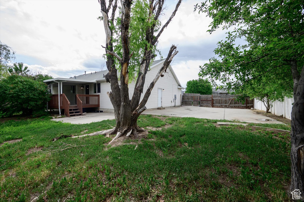 View of yard with a patio and a deck