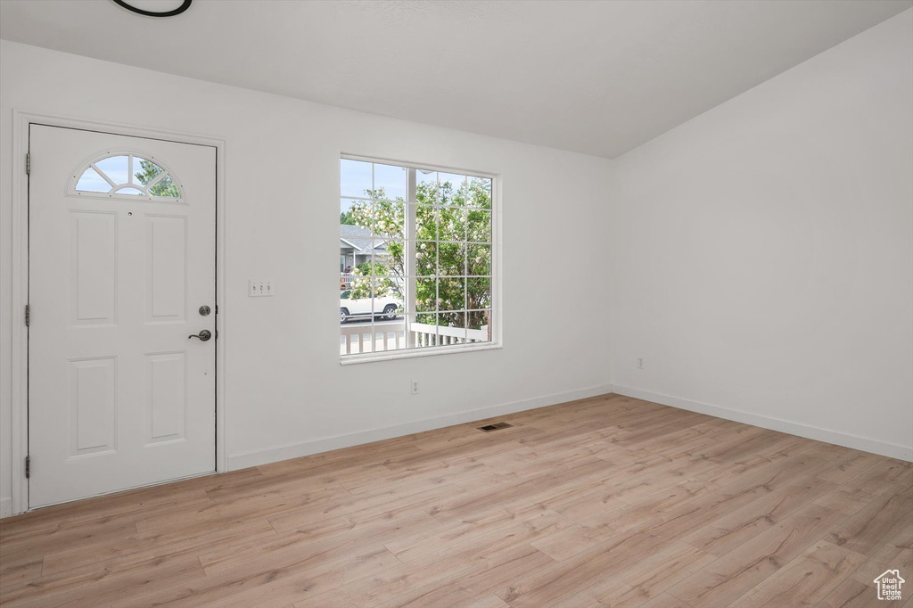 Entryway with light wood-type flooring and baseboards