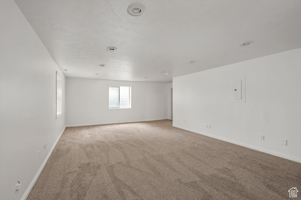 Unfurnished room featuring light colored carpet and baseboards
