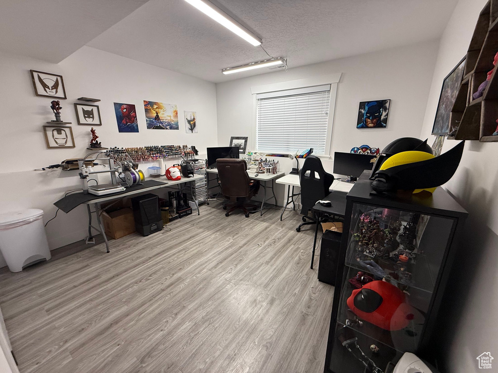 Office area with wood finished floors and a textured ceiling