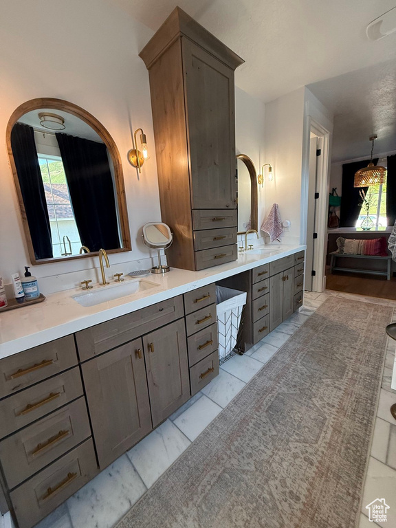 Bathroom featuring vanity and healthy amount of natural light