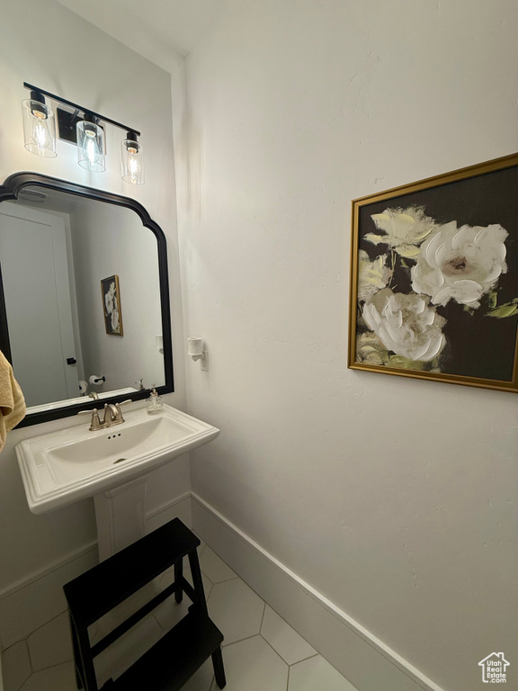 Bathroom with tile patterned floors and baseboards