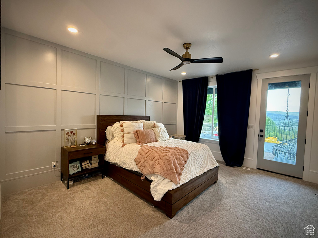 Bedroom with a decorative wall, access to outside, light carpet, recessed lighting, and a ceiling fan