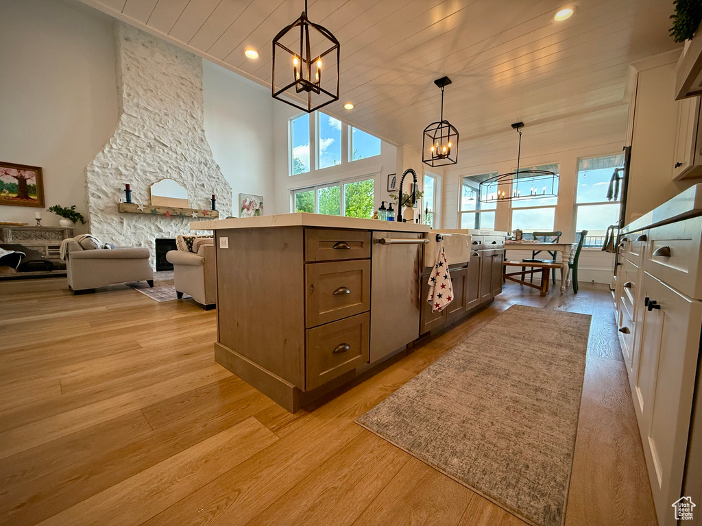 Kitchen with a chandelier, healthy amount of natural light, open floor plan, light wood-style flooring, and recessed lighting
