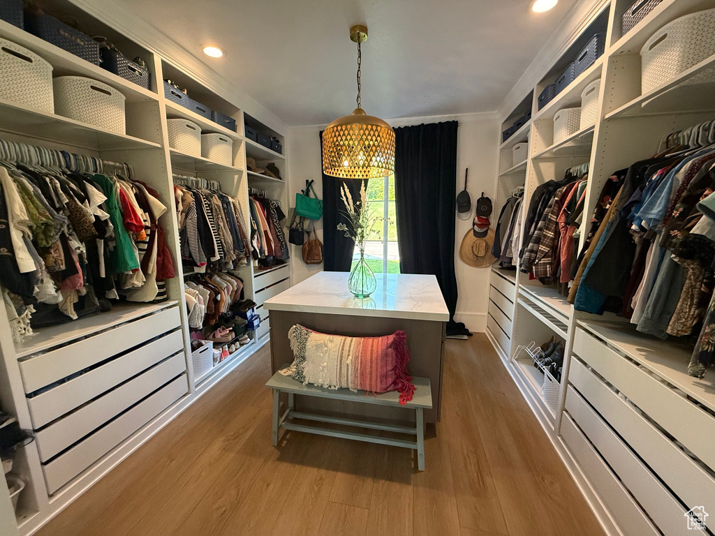 Walk in closet featuring wood finished floors
