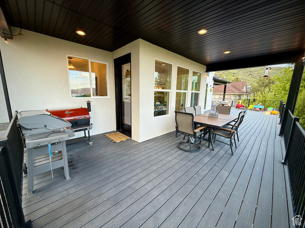 Wooden deck featuring outdoor dining area