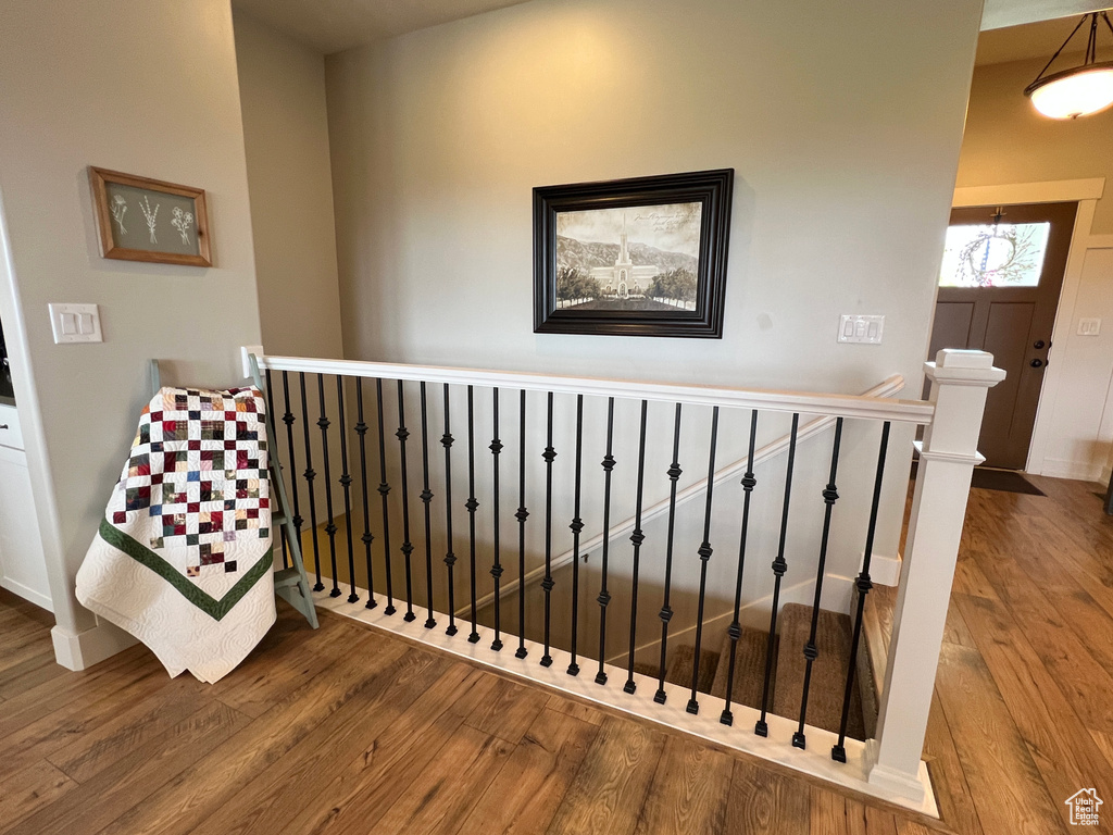 Staircase featuring wood finished floors and baseboards
