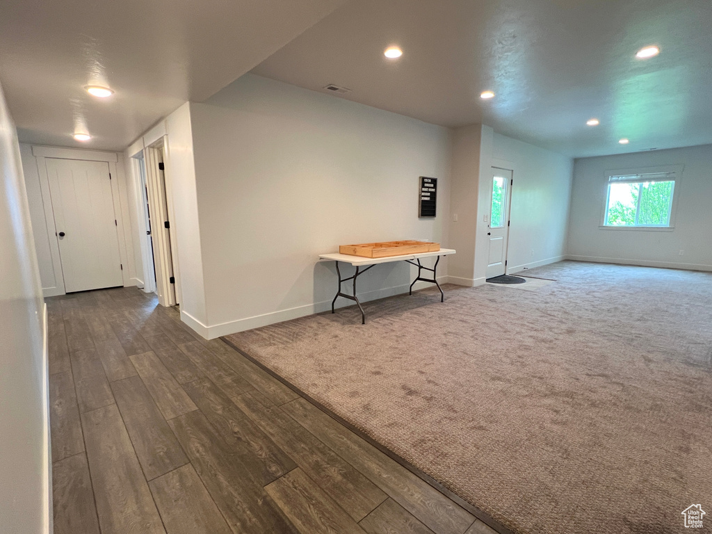 Spare room with baseboards, recessed lighting, and wood finished floors
