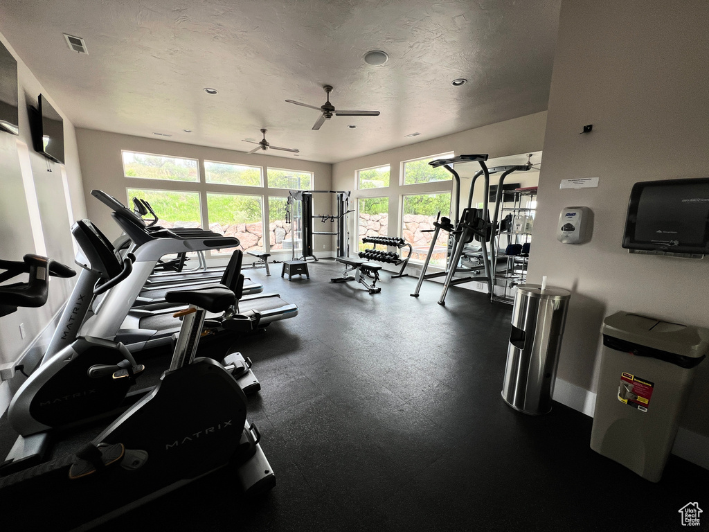 Workout area featuring ceiling fan and baseboards