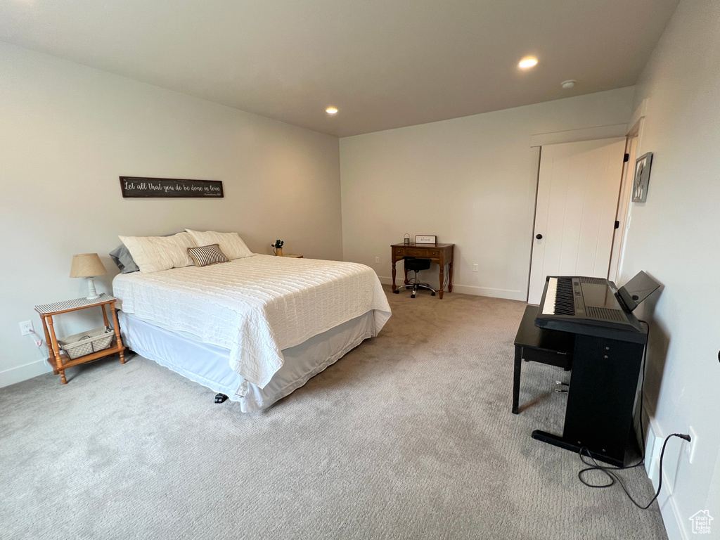 Carpeted bedroom with recessed lighting and baseboards