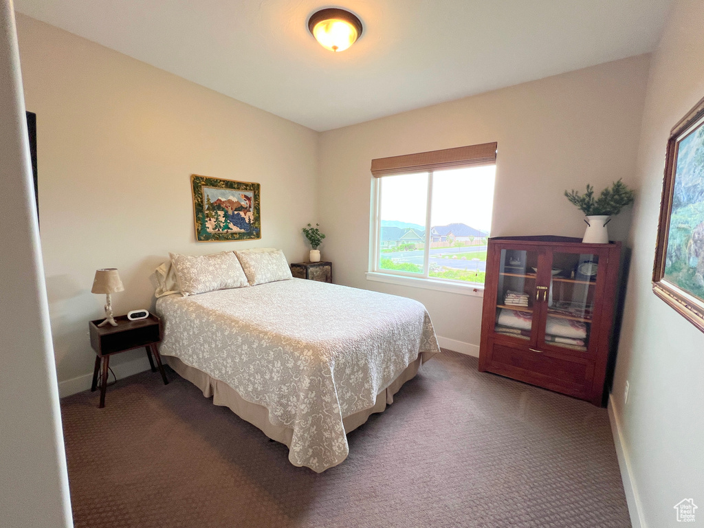 Carpeted bedroom featuring baseboards
