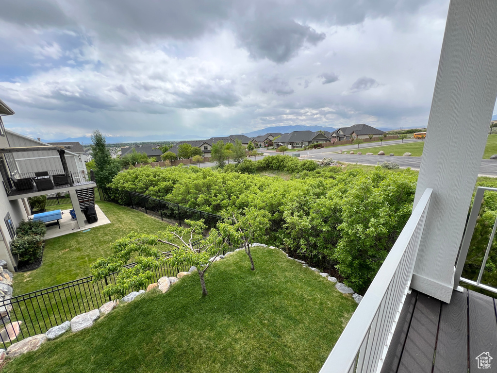View of yard with a residential view and a balcony