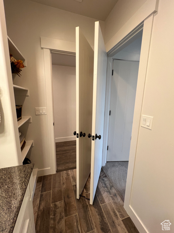 Corridor with dark wood finished floors