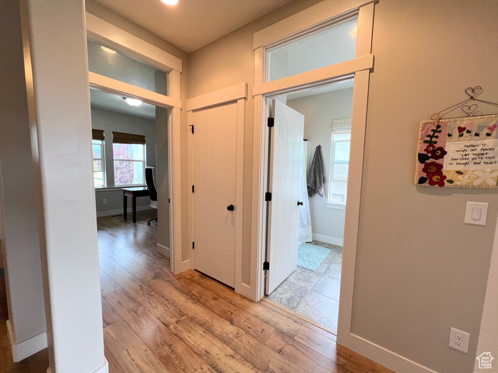 Hall featuring light wood finished floors and baseboards