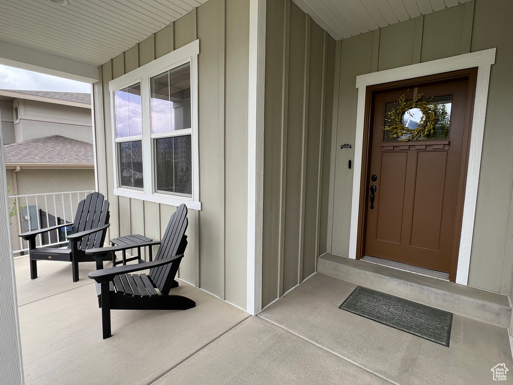 Entrance to property featuring board and batten siding and a porch