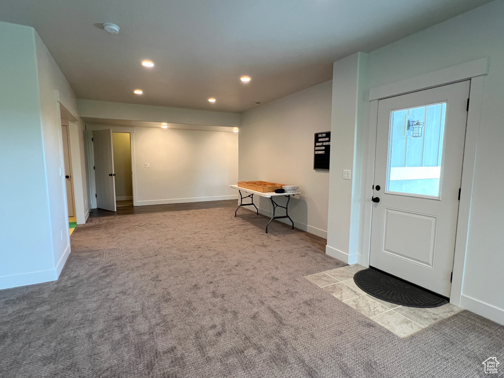 Carpeted entryway featuring recessed lighting and baseboards